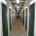 The interior of the building has an open ceiling with center mounted lights. When planning interior spaces, developers may select a soffit ceiling, full flush ceiling, leave it open as seen here, or supply their own materials. Center mounted lighting is advisable to best illuminate storage units without placing lights in the units.