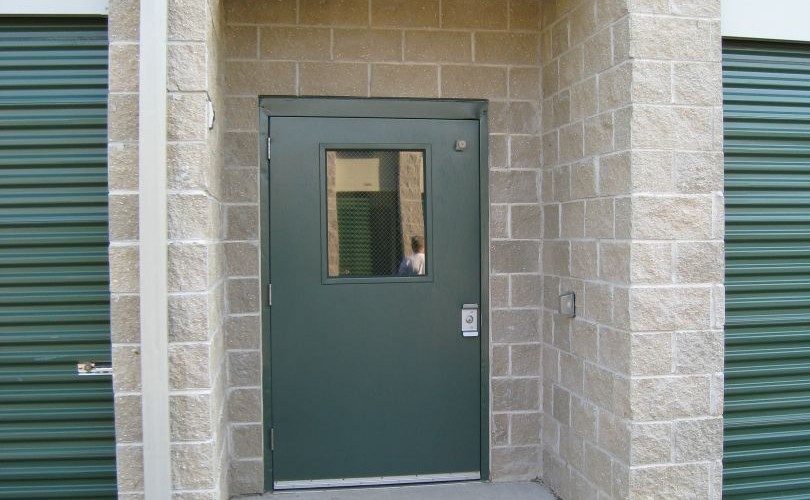 A recessed entry provides sheltered access, and may be built from block, as shown, or from steel. In this photo you can also see that the downspouts drain water directly to underground piping. 