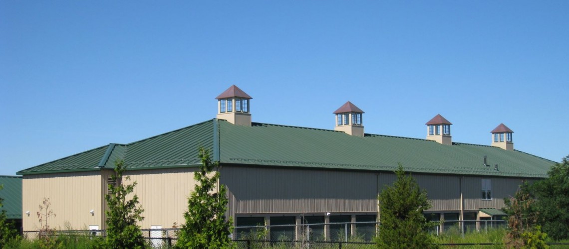 The two story building features a hipped, high pitched roof. 