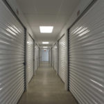 Ceiling tiles and recessed lighting combine for a clean look in this corridor.