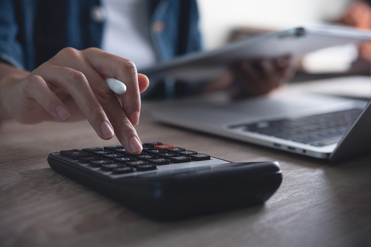 close up of person using calculator
