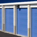 This iced white self-storage building with royal blue doors utilizes a two-tone block perimeter.