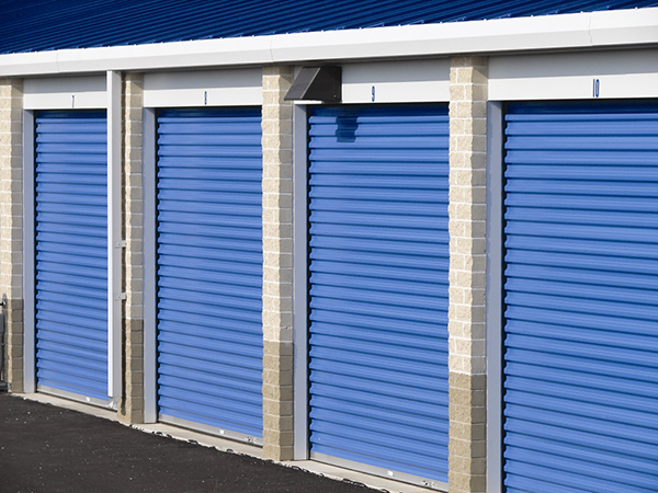 This iced white self-storage building with royal blue doors utilizes a two-tone block perimeter.