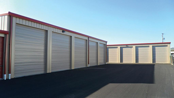 Large boat/RV storage with sectional doors and corrugated jambs and headers.
