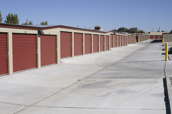 The rolling step self-storage building is classic beige with cedar red trim and doors. 