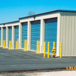 This building features large roll up doors, and is stepped to follow the elevation change. Bollards are position to protect the building and fire hydrant.